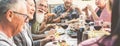 Happy family people having fun at barbecue dinner - Multiracial friends eating at bbq meal - Food, friendship, relationship and Royalty Free Stock Photo