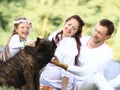 happy family with pet dog at picnic in a Sunny summer day. pregn Royalty Free Stock Photo