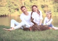 happy family with pet dog at picnic in a Sunny summer day. pregn Royalty Free Stock Photo