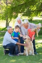 Happy family petting their dog Royalty Free Stock Photo