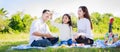 Happy family picnic. Asian parents Father, Mother and daughter playing the toy airplane and have enjoyed ourselves together whil