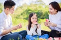 Happy family picnic. Asian parents Father, Mother and little girl eating watermelon and have fun and enjoyed ourselves together