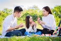 Happy family picnic. Asian parents Father, Mother and little girl eating watermelon and have fun Royalty Free Stock Photo