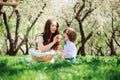 Happy family on picnic for mothers day. Mom and toddler son eating sweets outdoor in spring Royalty Free Stock Photo