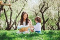 Happy family on picnic for mothers day. Mom and toddler son eating sweets outdoor in spring Royalty Free Stock Photo