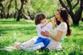 Happy family on picnic for mothers day. Mom and toddler son eating sweets outdoor in spring Royalty Free Stock Photo