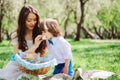 Happy family on picnic for mothers day. Mom and toddler son eating sweets outdoor in spring Royalty Free Stock Photo