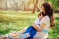 Happy family on picnic for mothers day. Mom and toddler son eating sweets outdoor in spring or summer Royalty Free Stock Photo