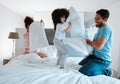 Happy family, pillow fight and playing on bed in the morning together for fun bonding at home. Father, mother and Royalty Free Stock Photo