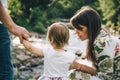 Happy family play with daughter near the river in mountains Royalty Free Stock Photo