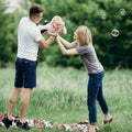 Happy family play outdoors, blowing soap bubbles Royalty Free Stock Photo