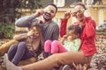 Happy family playing at backyard, go hide with leaves. Royalty Free Stock Photo