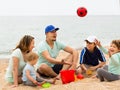 Happy family playing with ball at sandy beach Royalty Free Stock Photo