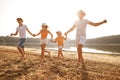 Happy family playing on the beach at sunset Royalty Free Stock Photo