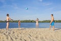 Happy family playing beach volleyball by the river on a sunny day. lifestyle Royalty Free Stock Photo