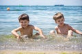 Happy family playing in blue water of swimming pool on a tropical resort at the sea. Summer vacations concept. Two brother kids Royalty Free Stock Photo