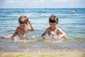 Happy family playing in blue water of swimming pool on a tropical resort at the sea. Summer vacations concept. Two brother kids Royalty Free Stock Photo