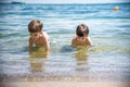 Happy family playing in blue water of swimming pool on a tropical resort at the sea. Summer vacations concept. Two brother kids Royalty Free Stock Photo