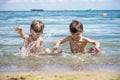 Happy family playing in blue water of swimming pool on a tropical resort at the sea. Summer vacations concept. Two brother kids Royalty Free Stock Photo
