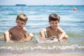 Happy family playing in blue water of swimming pool on a tropical resort at the sea. Summer vacations concept. Two brother kids Royalty Free Stock Photo