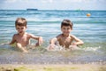 Happy family playing in blue water of swimming pool on a tropical resort at the sea. Summer vacations concept. Two brother kids Royalty Free Stock Photo