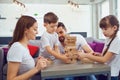 Happy family playing board games at home.