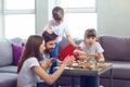 Happy family playing board games at home.