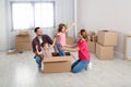 Happy family playing with cardboard box in their house. Moving day Royalty Free Stock Photo