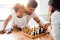 Happy family playing chess together Royalty Free Stock Photo