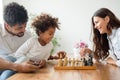 Happy family playing chess together Royalty Free Stock Photo