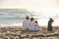 Happy family playing with dog on beach Royalty Free Stock Photo