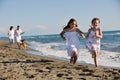 Happy family playing with dog on beach Royalty Free Stock Photo