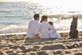 Happy family playing with dog on beach Royalty Free Stock Photo