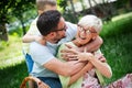 Happy family playing and enjoying picnic with children outside