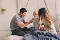 Happy family playing at home on the bed. Lifestyle capture of mother, father and baby Royalty Free Stock Photo