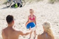 Happy family playing with inflatable ball on beach Royalty Free Stock Photo