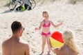 Happy family playing with inflatable ball on beach Royalty Free Stock Photo