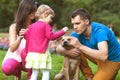 Happy family playing in the park with his dog Royalty Free Stock Photo