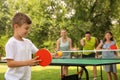 Happy family playing ping pong in park Royalty Free Stock Photo