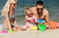Happy family playing with sand toys on beach Royalty Free Stock Photo