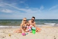 Happy family playing with sand toys on beach Royalty Free Stock Photo