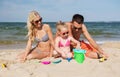 Happy family playing with sand toys on beach Royalty Free Stock Photo