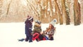 Happy family playing with snow in winter park. Lovely kids and young mother having fun together in winter outdoors. Winter Royalty Free Stock Photo