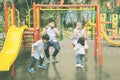 Happy family playing soap bubble at playground