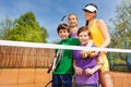 Happy family after playing tennis in summertime Royalty Free Stock Photo