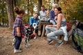 A happy family playing with their dog in the forest Royalty Free Stock Photo