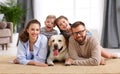 Happy family playing with their favorite pet dog   at home Royalty Free Stock Photo