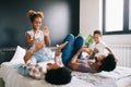 Happy family playing together on a bed at home Royalty Free Stock Photo