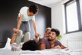 Happy family playing together on a bed at home Royalty Free Stock Photo