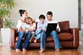 Happy family playing together with a laptop Royalty Free Stock Photo